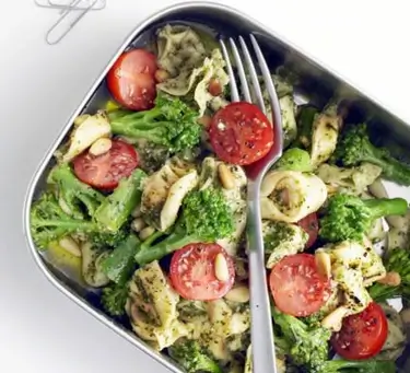 An image of pasta a vegetables in a food container.